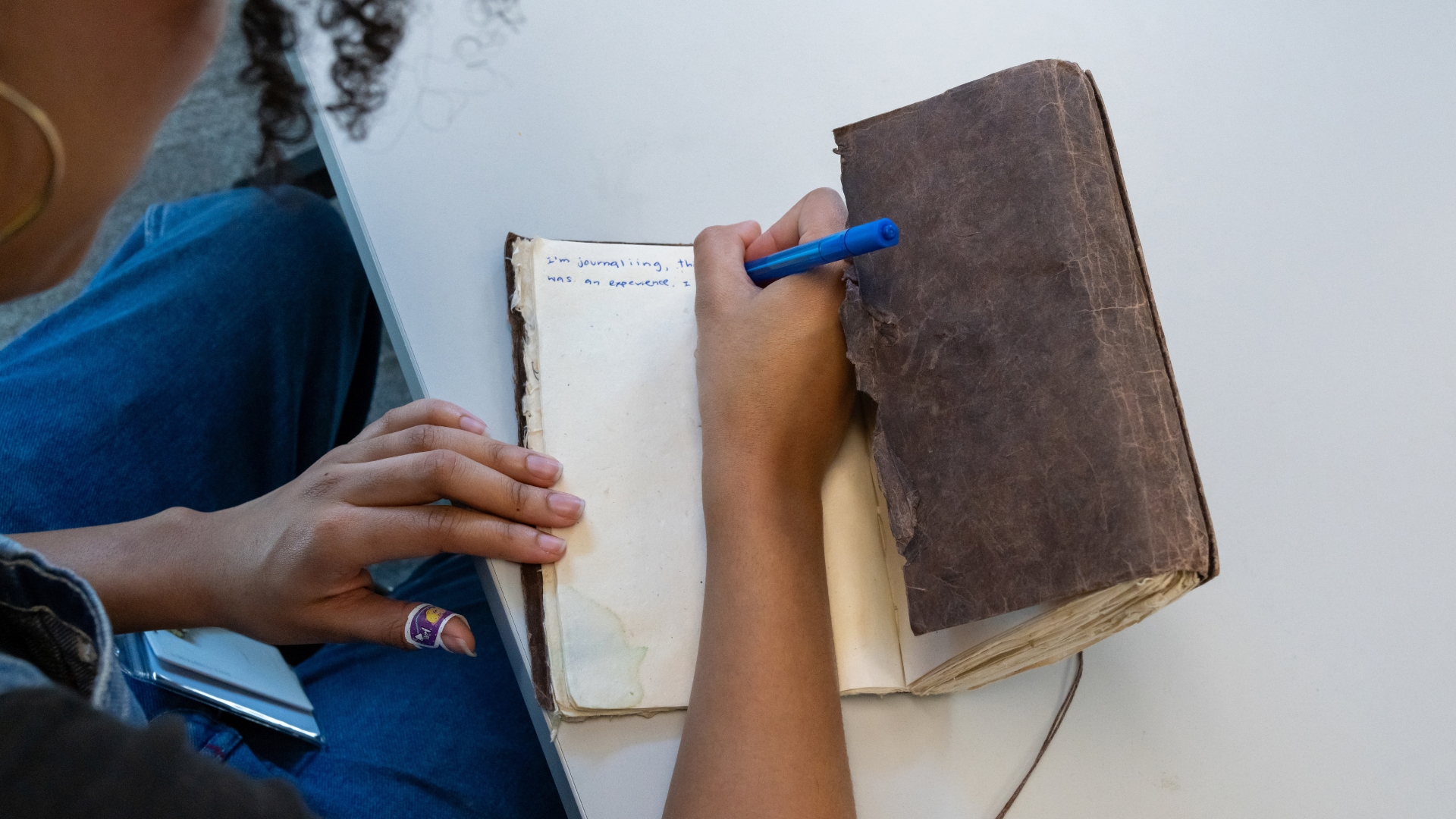 person writing in a notebook